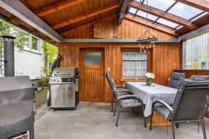 a patio with a table and chairs and a stove at Fewo Fürst in Moos