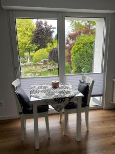 a table and chairs in a room with a window at Haus Am Damm in Kleve