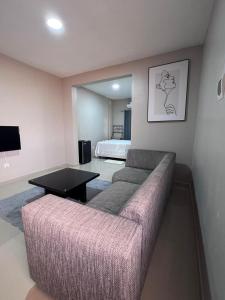 a living room with a couch and a bed at Residencial Biva in Namibe +39 photos
