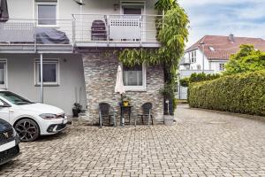 a white car parked in front of a house at Fewo Fürst in Moos
