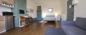a living room with a bed and a kitchen at Le Chapitre Français 3 in Rochechouart +31 photos