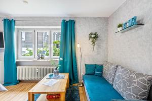 a living room with a blue couch and a table at Fewo Fürst in Moos