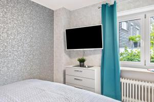a bedroom with a bed and a tv on a wall at Fewo Fürst in Moos +20 photos