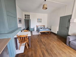 a living room with a bed and a couch at Le Chapitre Français 3 in Rochechouart