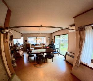 a dining room and living room with a table at Tsumugu dom in Ueda