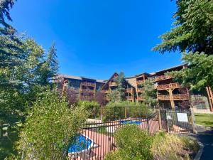 an apartment building with a fence and trees at Tenderfoot Lodge 2620 by SummitCove Lodging in Colorado in Keystone +32 photos