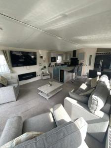 a large living room with couches and a tv at JLUX Lodges in Crowle