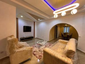 a living room with two couches and a tv at Kelvin Cameo Resort Hotel in Madala