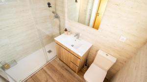 a bathroom with a sink and a toilet and a mirror at Casa da Moura - Arcos de Valdevez in Arcos de Valdevez +25 photos