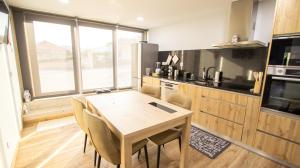 a kitchen with a table and chairs in a room at Casa da Moura - Arcos de Valdevez in Arcos de Valdevez