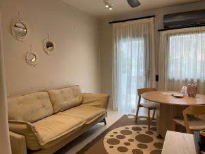 a living room with a couch and a table at Vaios Luxury Apartments in Polychrono