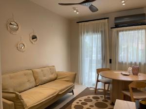 a living room with a couch and a table at Vaios Luxury Apartments in Polychrono +14 photos