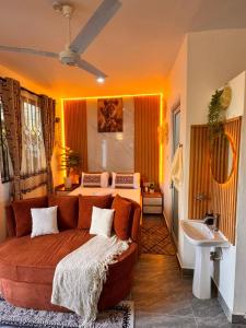 a bedroom with a couch and a bed and a sink at Homes by Najma in Mtwapa +15 photos