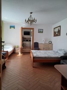 a bedroom with two beds and a chandelier at Dworek in Swarzewo