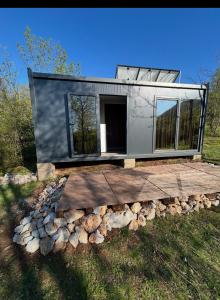 a tiny house on a pile of logs at OffGrid Retreat Rtanj in Boljevac