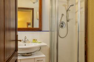 a bathroom with a sink and a shower at Villa Montebella Countryside Retreat in Montepulciano in Montepulciano
