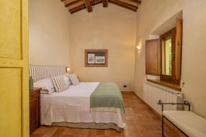 a small bedroom with a bed and a window at Villa Montebella Countryside Retreat in Montepulciano in Montepulciano