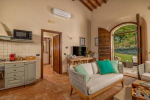 a living room with a couch and a kitchen at Villa Montebella Countryside Retreat in Montepulciano in Montepulciano