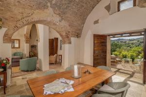 a dining room with a table and a brick wall at Villa Montebella Countryside Retreat in Montepulciano in Montepulciano +50 photos