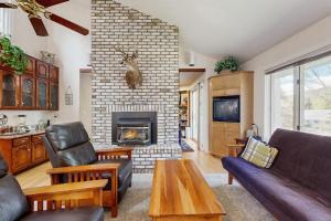 a living room with a fireplace and a couch and chairs at Paradise in Vermont in Warren