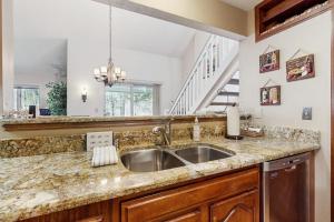 a kitchen with a sink and a staircase at Paradise in Vermont in Warren +51 photos
