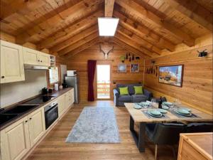 a kitchen and living room in a log cabin at Baita dell'Est in Mese