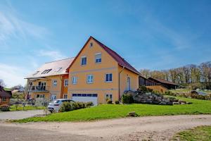 a large house with a car parked in front of it at Pferdefreunde Loberhof in Weihenzell