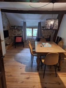 a dining room with a wooden table and chairs at gite Chèvre in La Chavière