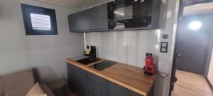 a kitchen with a counter with a sink and a microwave at SEA & SOUL SUITe in El Puerto de Santa María