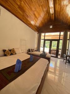 a bedroom with two beds and a large window at Nongkhaiw Hostel in Nongkhiaw +40 photos