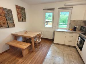 a kitchen with a wooden table and a table and chairs at Chalet Julian in Žaga