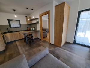 a kitchen and living room with a table and chairs at Casa Bassanello in Candide