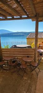 a patio with tables and chairs and a view of the water at chambres d'hôtes Les Fenières in Sainte-Croix-de-Verdon