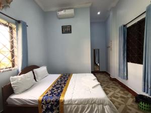 a bedroom with a large bed in a room at Good Day Kampot Guesthouse in Kampot