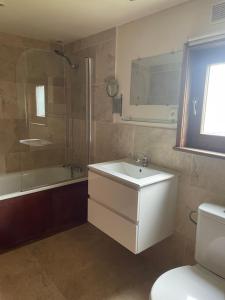 a bathroom with a sink and a shower and a toilet at La Bruyere in Saint-Pois