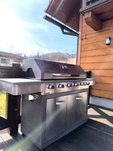 a grill sitting on a patio with aestead at Chata Valeriana Liptov in Ižipovce