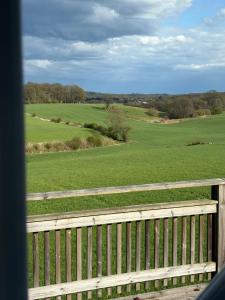 a view of a field from a wooden fence at Tant Märtas rum & skafferi in Köinge +7 photos