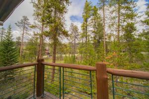 a balcony with a view of a forest at Starfire 1979 by SummitCove Lodging in Colorado in Keystone