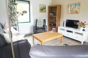 a living room with a couch and a coffee table at Kustverhuur, Park Schoneveld, Zeemeeuw 138 in Breskens