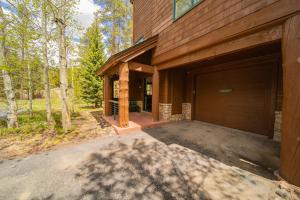 a house with a large garage in the woods at Starfire 1979 by SummitCove Lodging in Colorado in Keystone