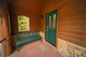 a porch with a green door and a window at Starfire 1979 by SummitCove Lodging in Colorado in Keystone