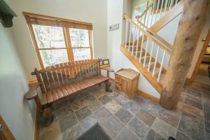 a room with a wooden bench and a staircase at Starfire 1979 by SummitCove Lodging in Colorado in Keystone +62 photos