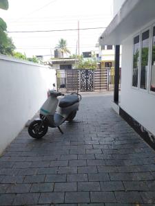 a motor scooter parked next to a building at Ravi's beach villa in Alleppey +11 photos