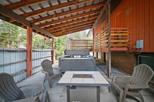 a patio with a grill and chairs and a table at Geyser Getaway in West Yellowstone