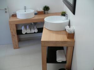 a bathroom with a sink on a wooden table at The Loft Junction in Funchal