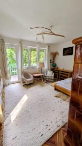 a bedroom with a bed and a table and windows at Gesztenyés Backpackers in Kőszeg