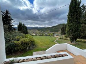 a balcony with a view of a green field at Casa Rural Mandala Riópar in Riópar