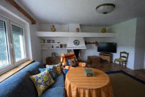 a living room with a blue couch and a table at Casa Rural Mandala Riópar in Riópar