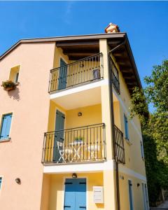 a building with a balcony on a building at Casa Incanto - Agenzia Cocal in Caorle