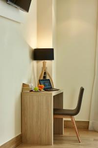 a desk with a chair and a laptop on it at Hotel Bilbao Plaza in Bilbao